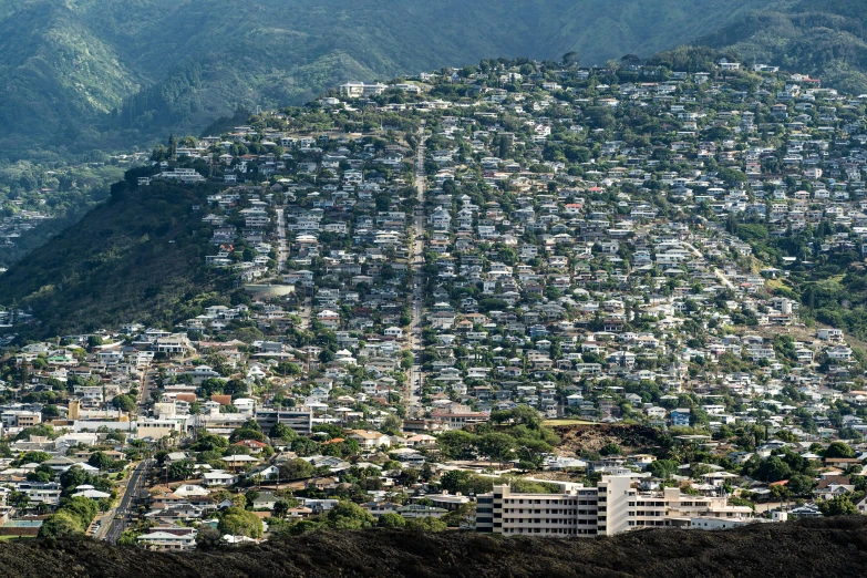 a large city surrounded by lush green mountains