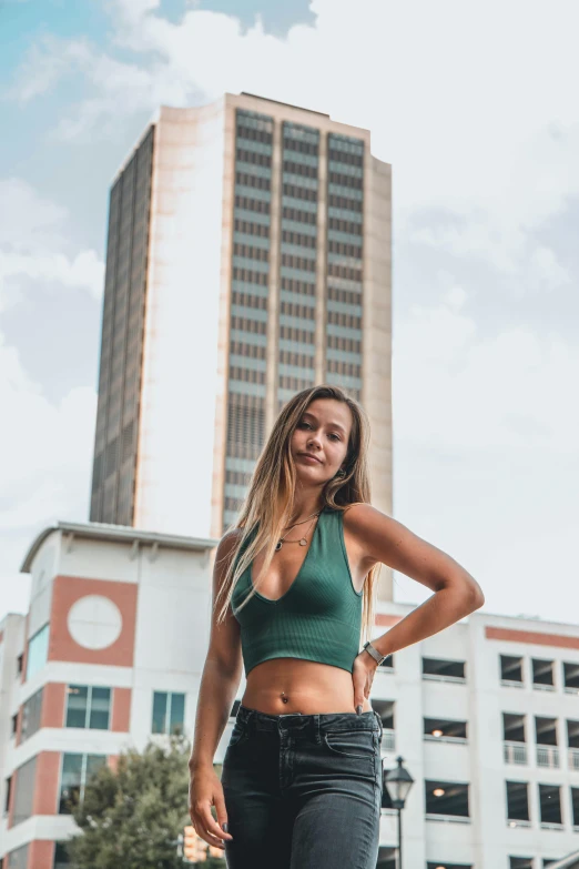 a beautiful young woman standing outside in front of a building