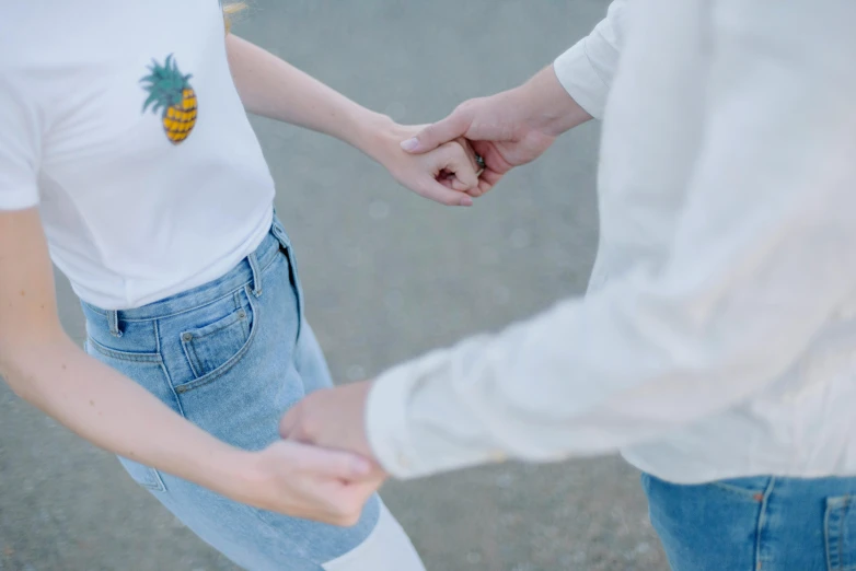 an image of two people holding hands together