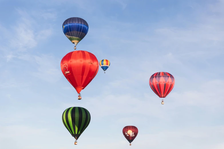 a group of multicolored balloons flying in the air
