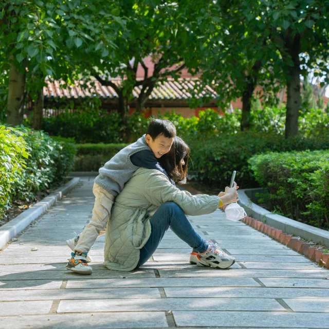 a young man and woman are squatting down holding hands