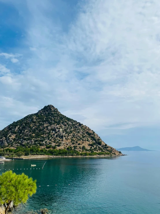 a small island near the water with a single boat on it