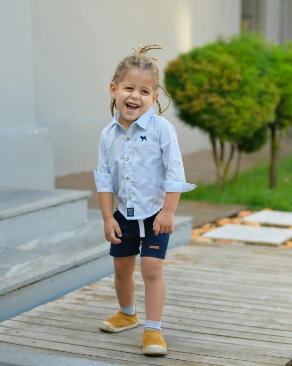 a little girl standing on some wooden steps