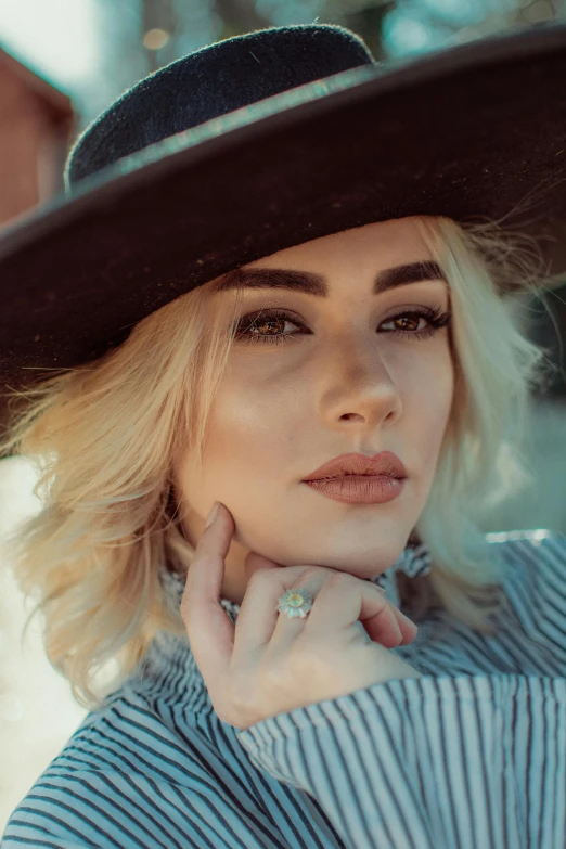 a young woman wearing a hat and standing