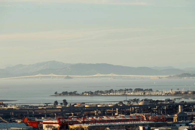 a large body of water with a hill and some buildings