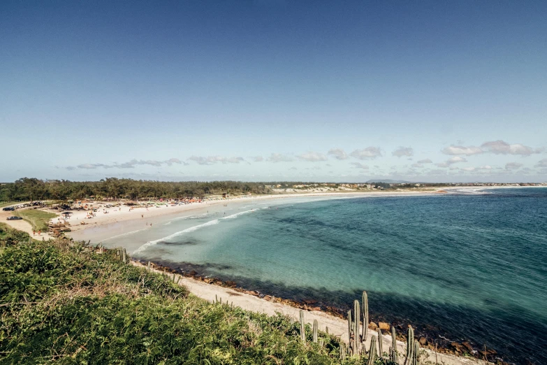 a wide s of an empty beach on the shore of the ocean