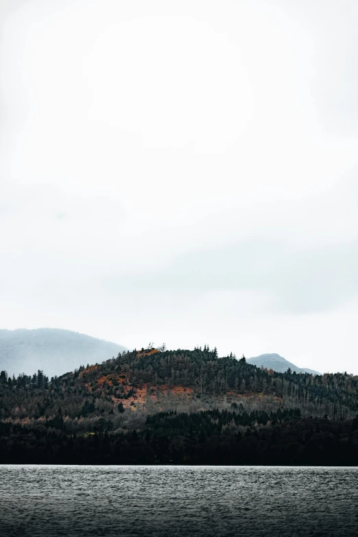 the hill tops are above the water in the background