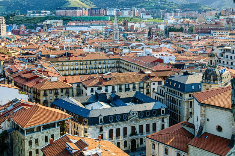 an aerial view of a city with mountains in the background