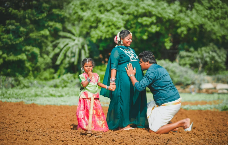 an adult kneeling down to greet a child