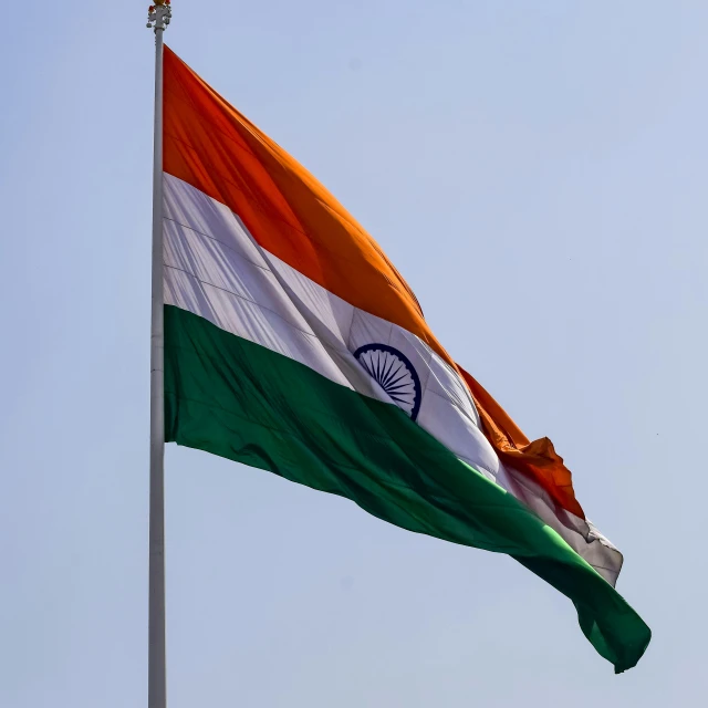 a very big flag flying on top of a pole