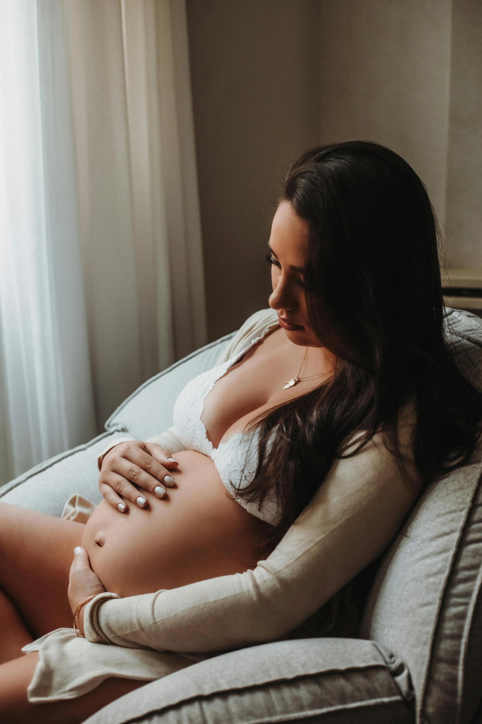 a pregnant woman sitting on top of a chair