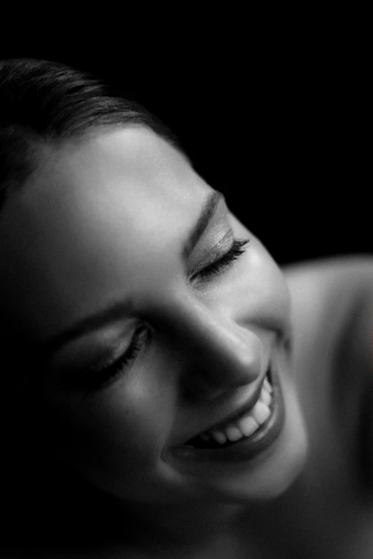 a woman smiles with her phone up to her ear