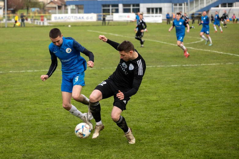 two soccer players are fighting over the ball