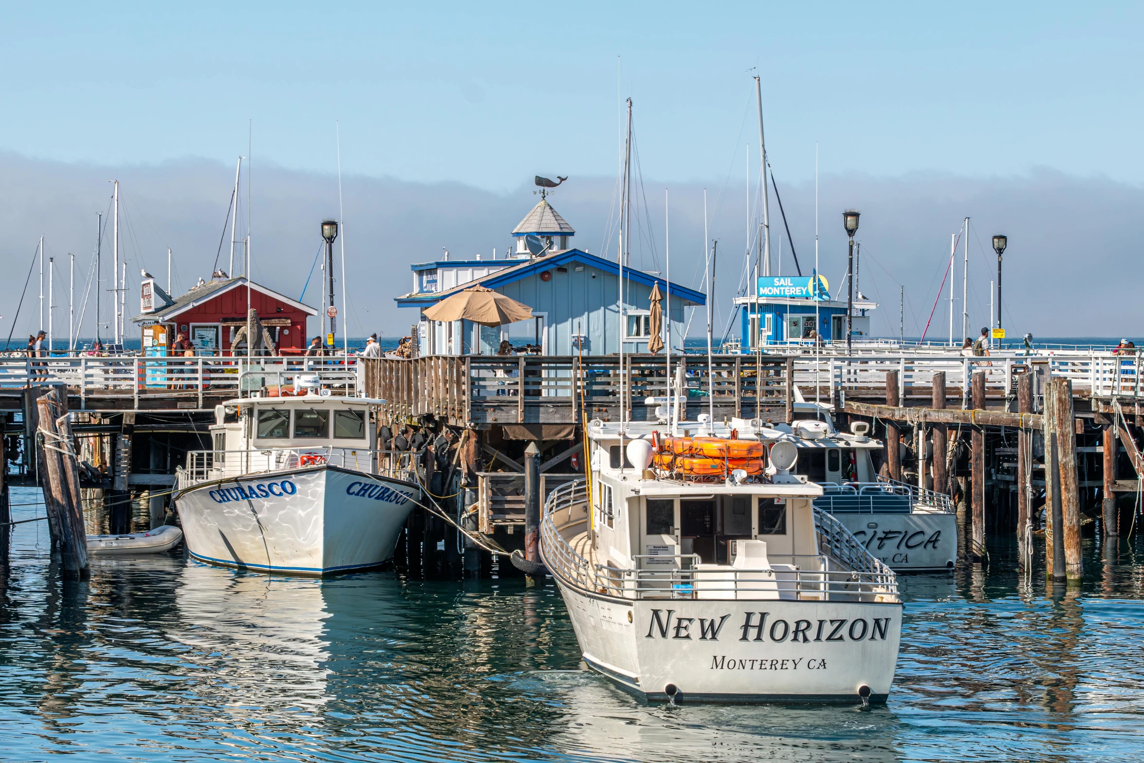 there are several boats that are docked on the water