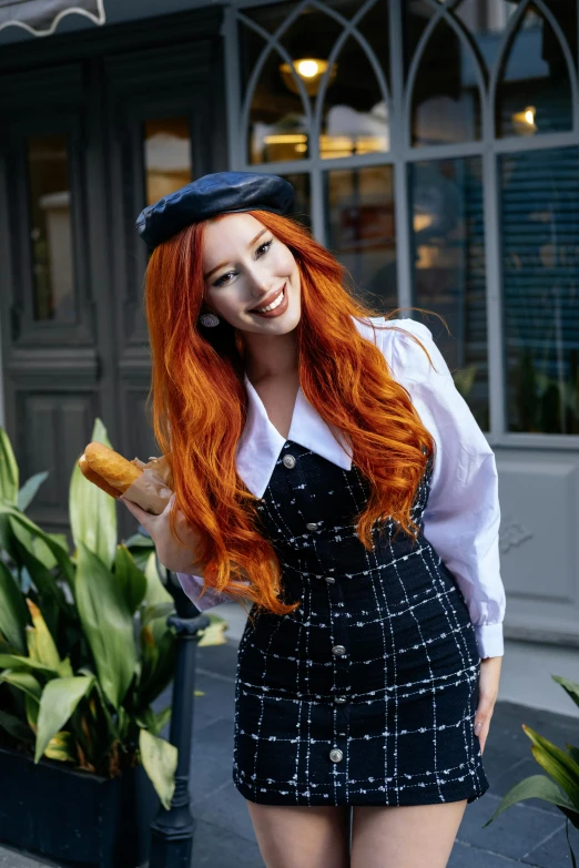 redhead woman posing outdoors wearing a pinafores with hat