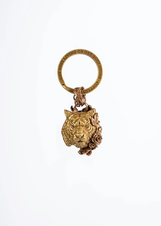 a pendant of gold metal with a chain, is shown