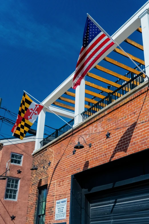 a brick building with an american flag on top