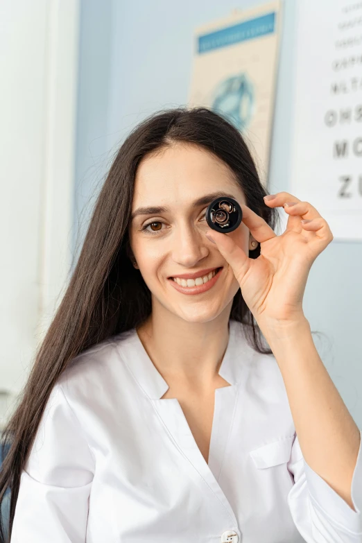 a woman wearing glasses smiles in a room