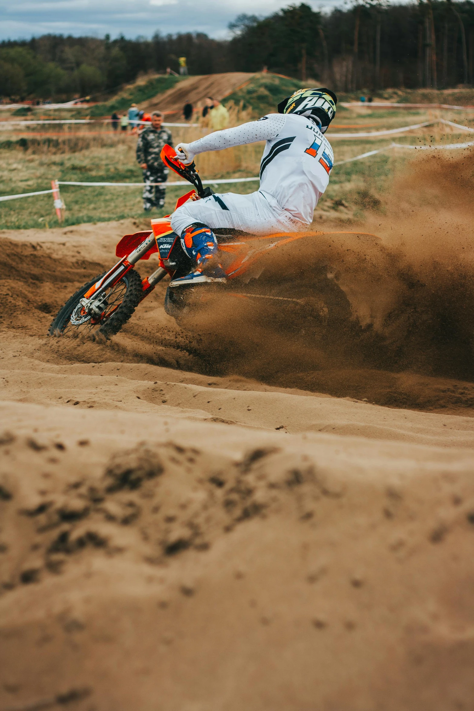 a motorcycle rider is making a dirt jump