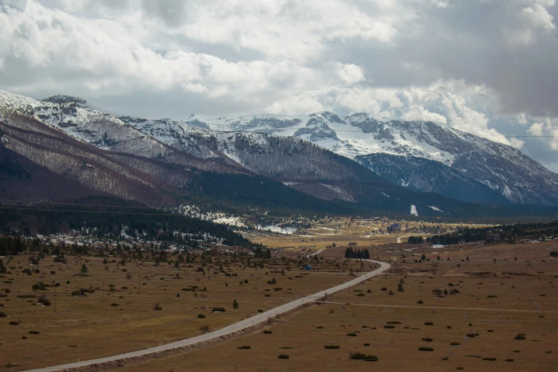 a scenic landscape view of a valley with mountains in the background