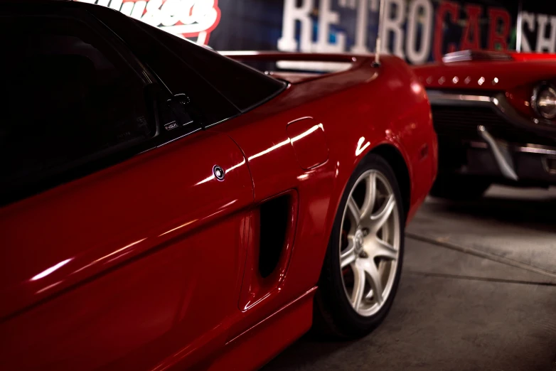 two cars are parked in a garage together