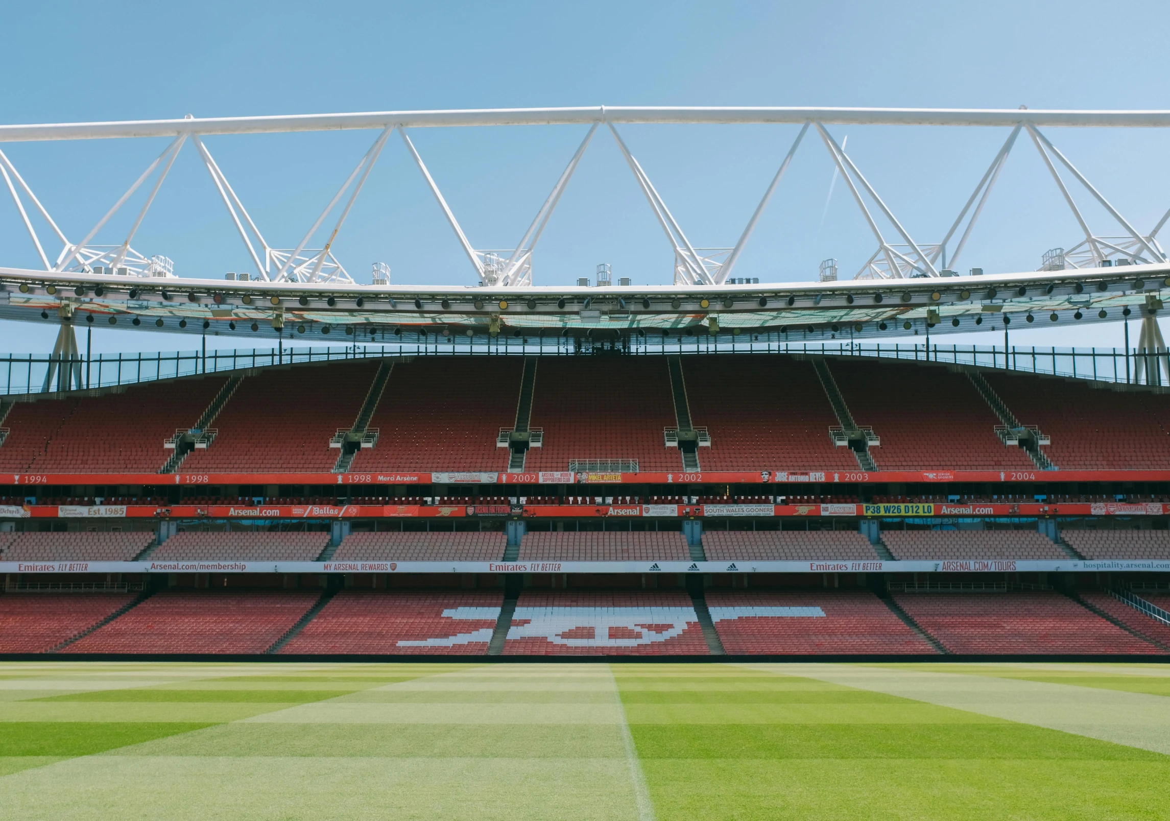 an empty stadium seat with a sky view