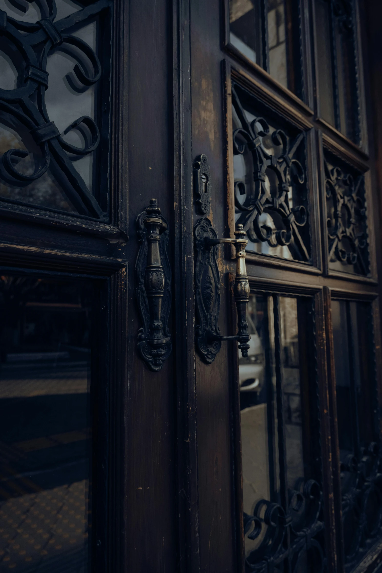 an ornate door is open and there is light on