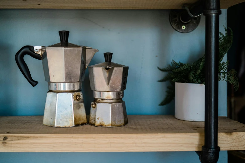 the coffee makers are on a shelf next to their respective cups