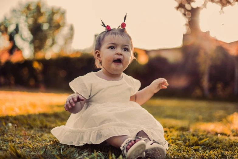 a toddler in the grass wearing some horns