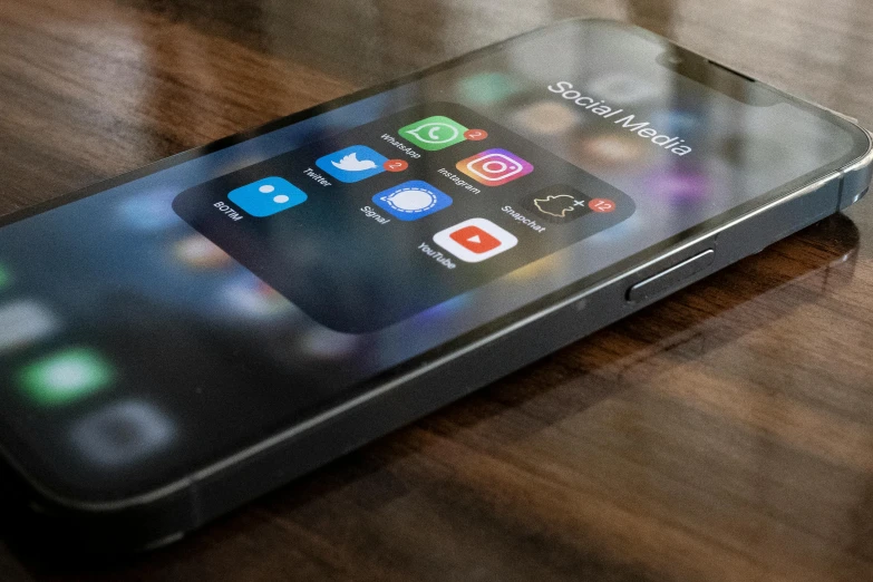 a close up of an iphone on a wooden table