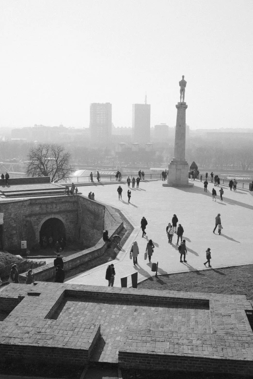 black and white pograph of people walking down a street