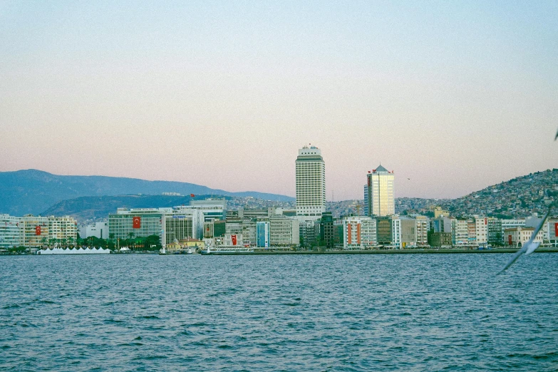 a body of water with a city in the background