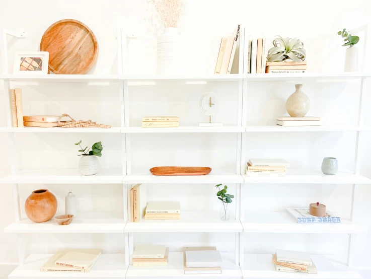 shelves of books with vases and other items on them