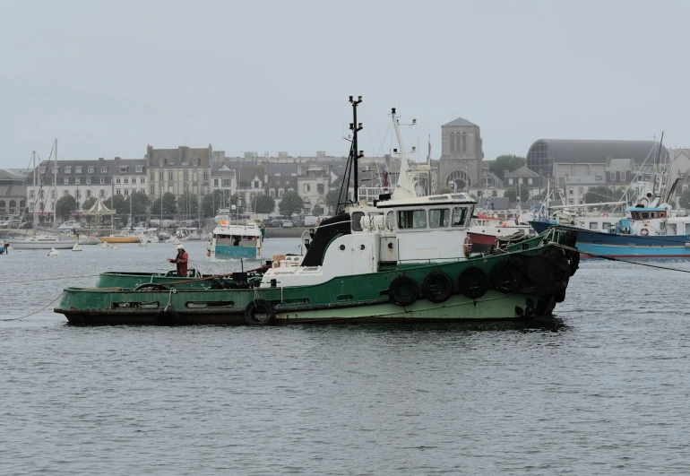 two tug boats are docked in the water