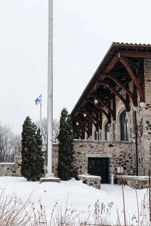 an old stone building on a snowy day