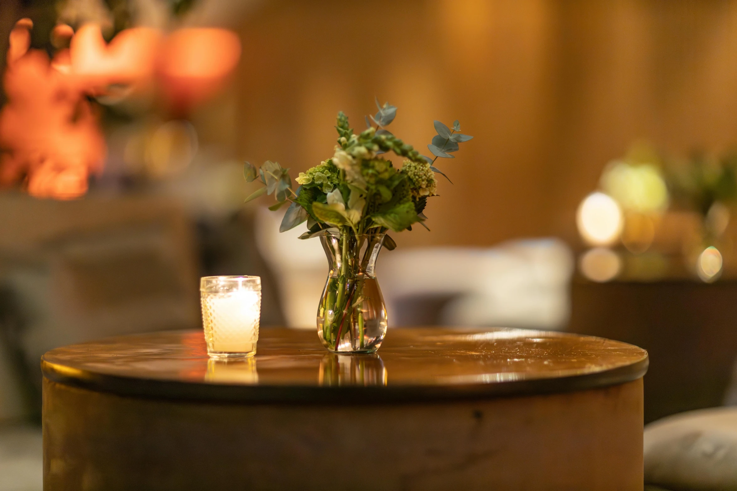 the flowers are arranged on top of the round table