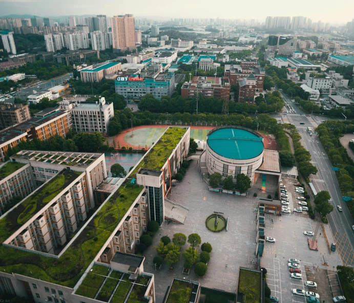 an aerial s of a park with cars and buildings