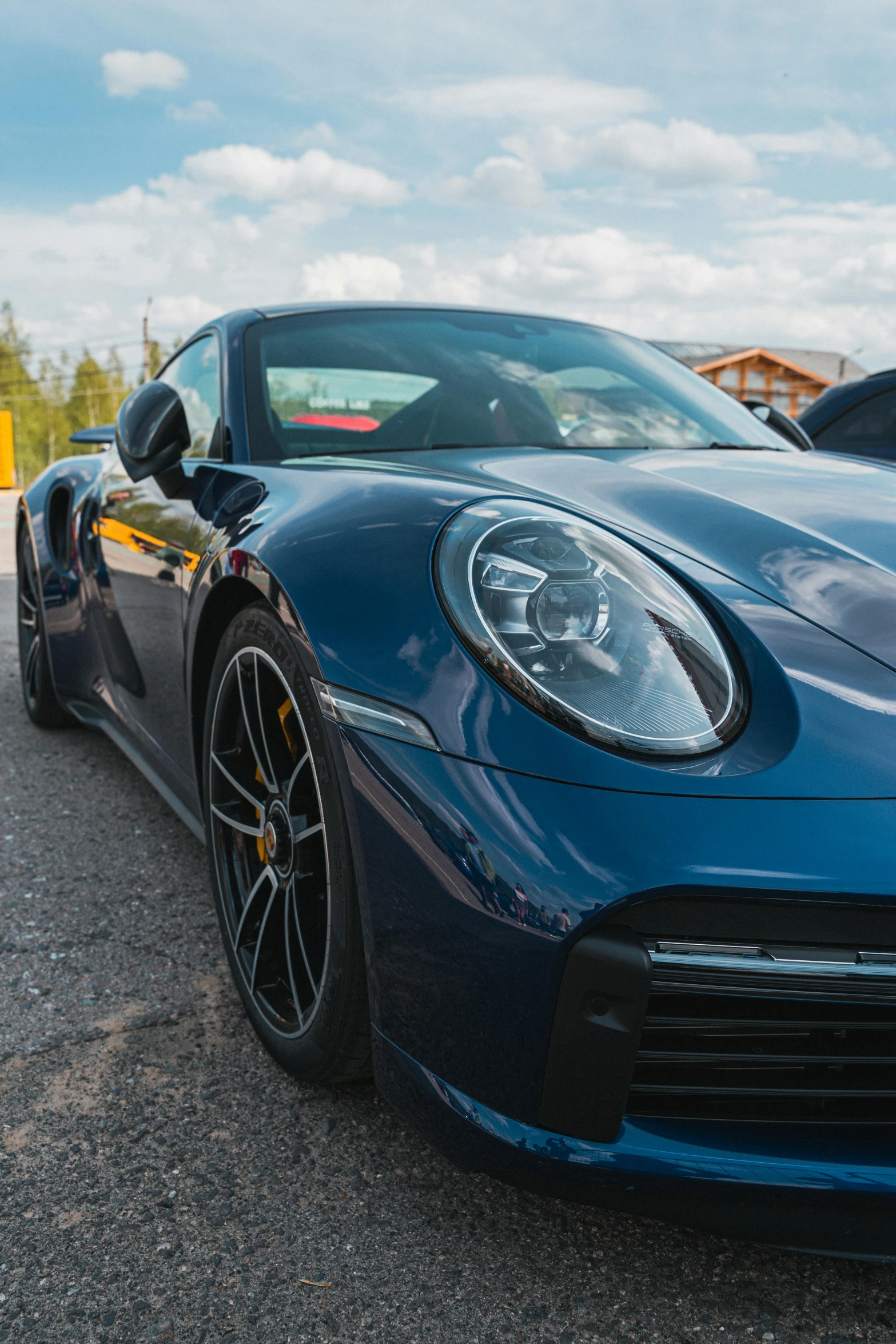 blue sports car sitting in the parking lot