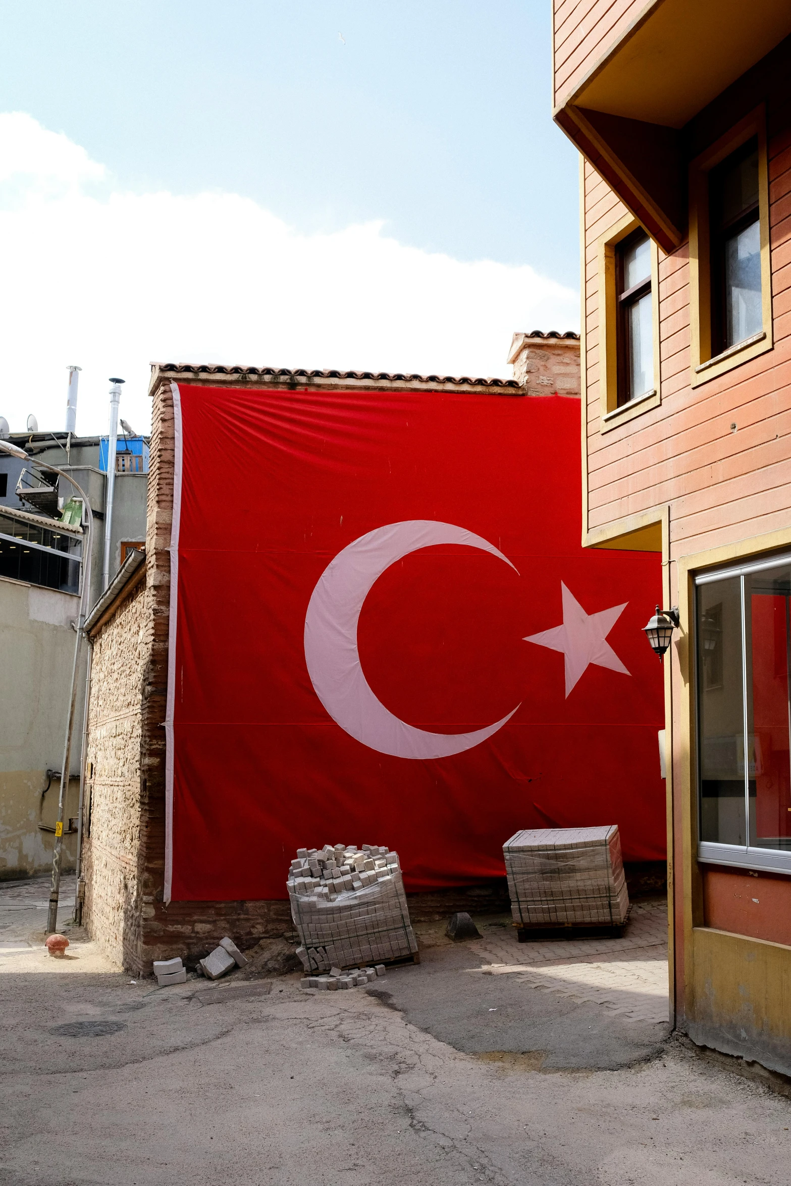 a big turkish flag next to a building