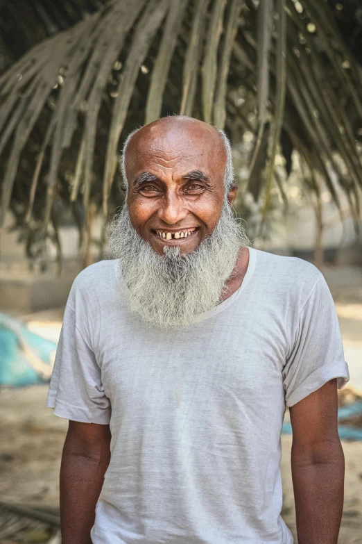 a man in a hat smiles at the camera