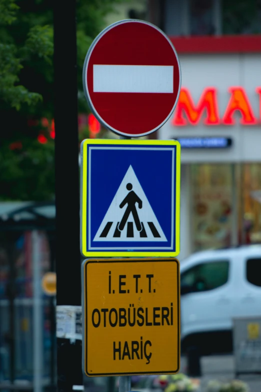 a close up of a traffic sign with another road sign