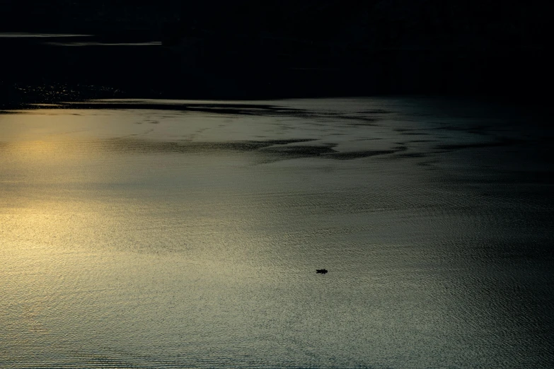 the sun is reflecting in the water on a body of water