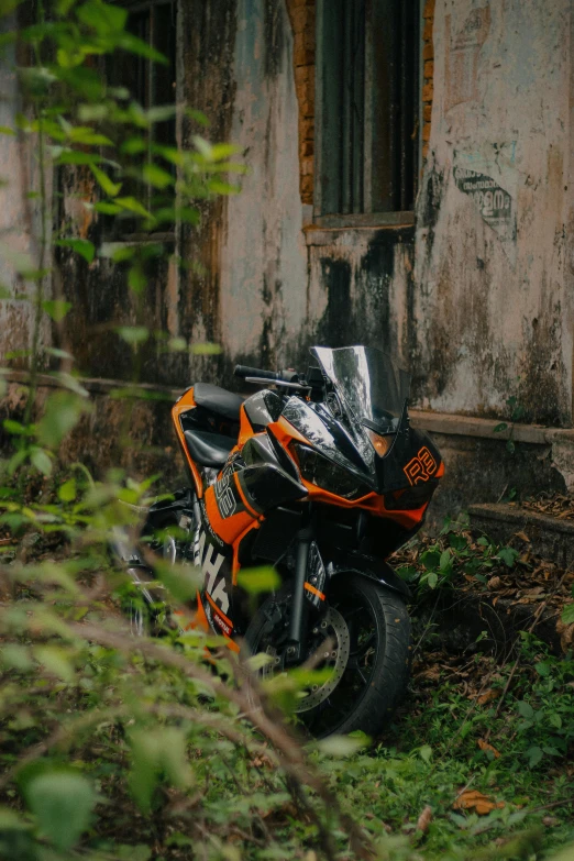 there is a motorcycle parked in front of a dilapidated house