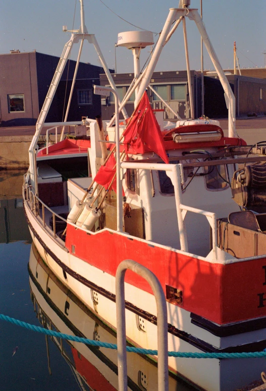 a red and white boat parked in a dock