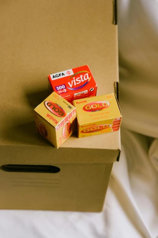 three boxes of tea and a sandwich box on a bed