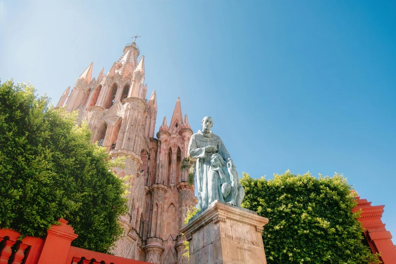 a statue of a person is standing in front of a castle