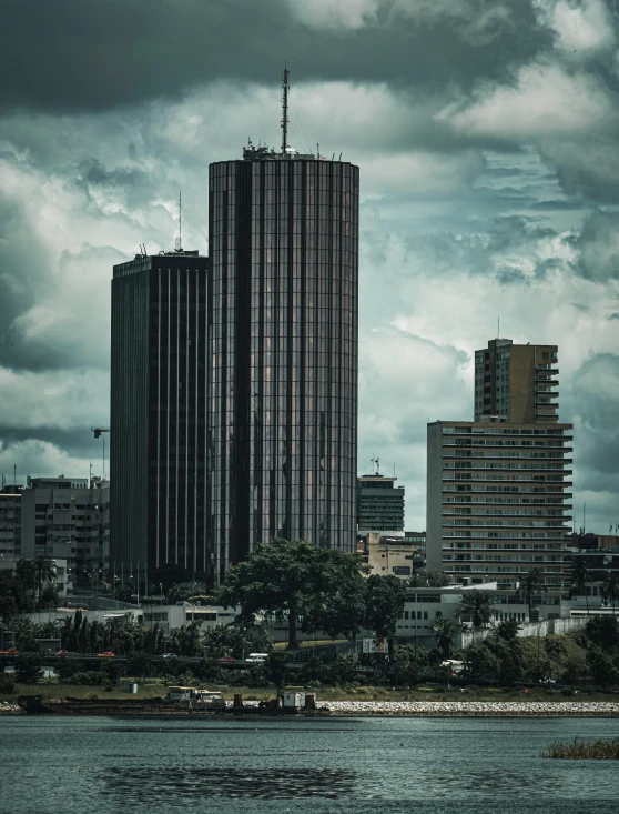 large buildings sit along the river bank near some buildings