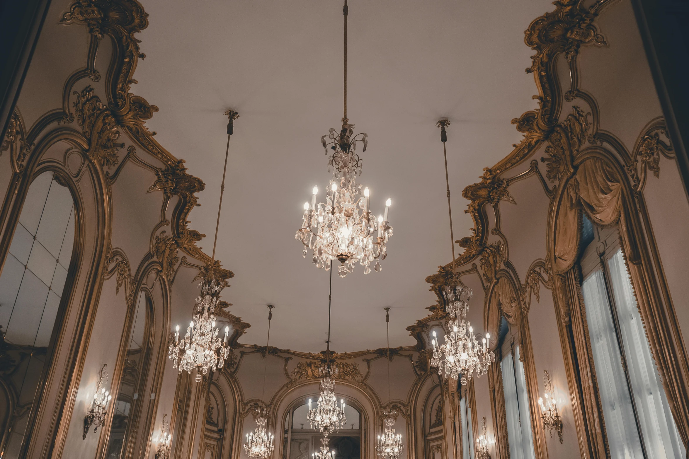 the ceiling of an elaborate hall lit with lights