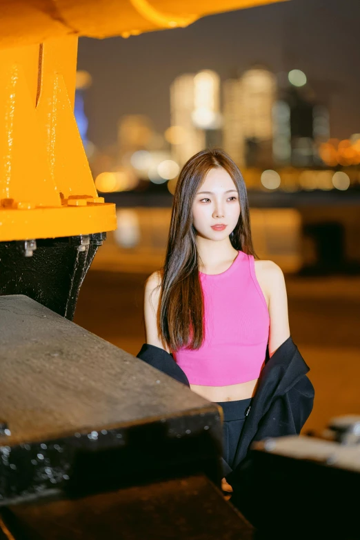 a young woman standing next to a yellow object