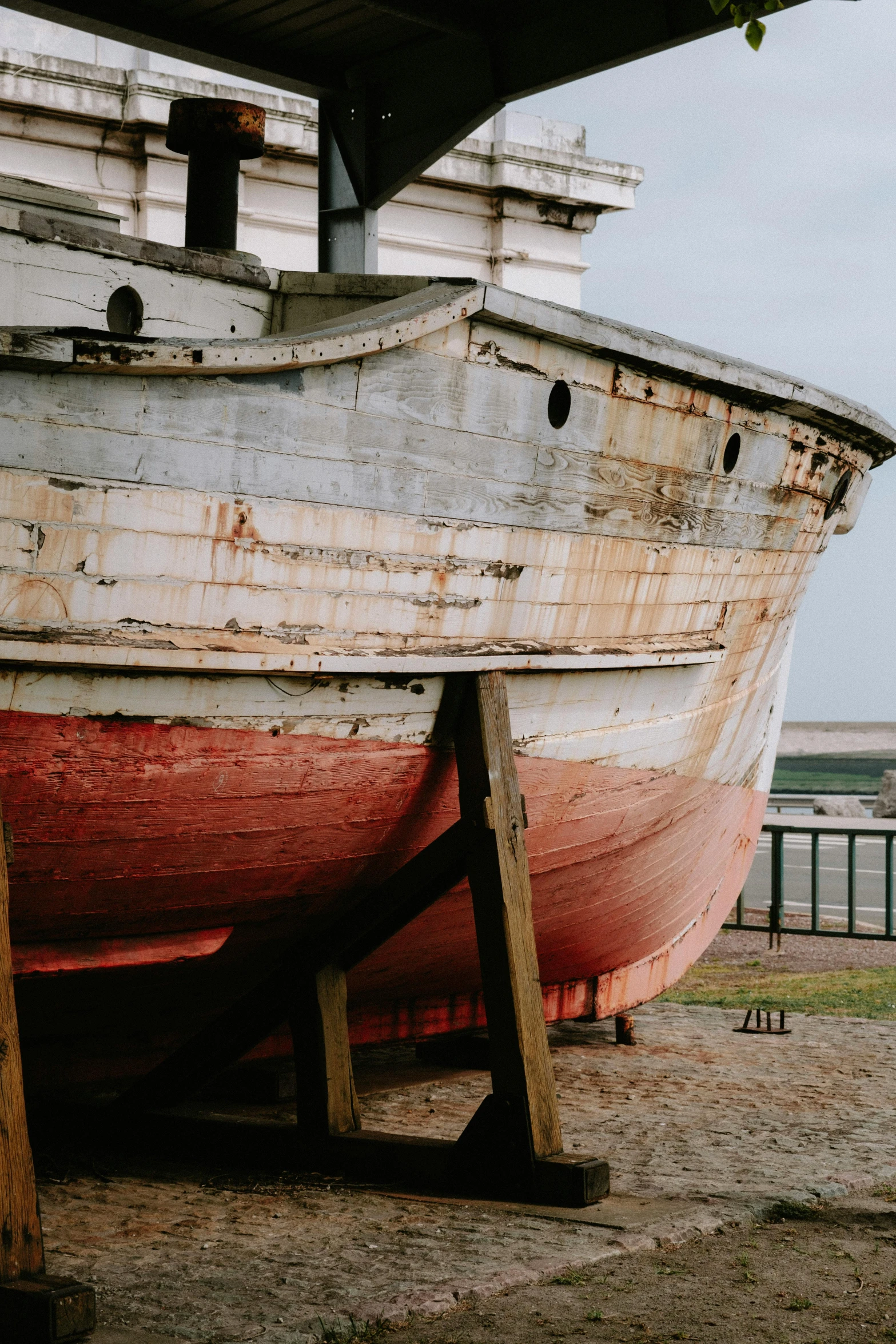 a large old wooden boat on the ground